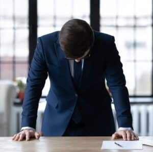 Executive with Imposter Syndrome Male executive experiencing Imposter Syndrome and self-doubt at work